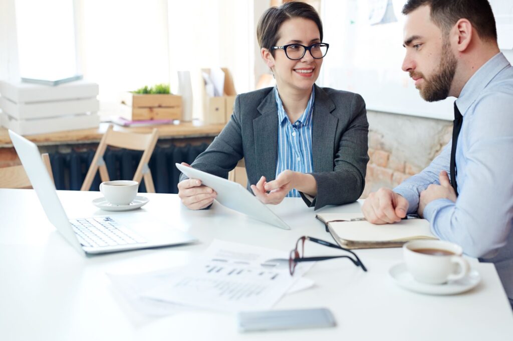 Woman discusses the details of the contract with man