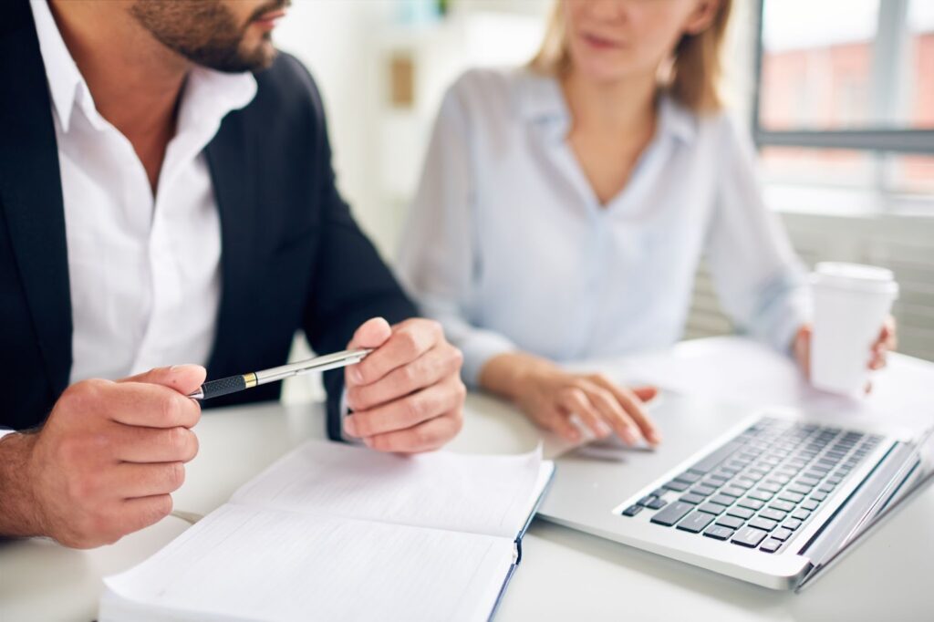 Close up of man and woman discussing business plan